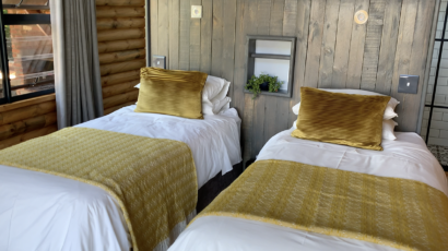 Arum Lily offers luxury accommodation, equipped with everything you need for an unforgettable stay! Two beds inside one of the bedrooms of a Arum Lily log cabin
